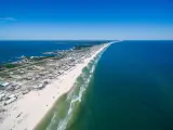 Aerial image of the Fort Morgan Peninsula stretching on the Gulf of Mexico on a sunny day