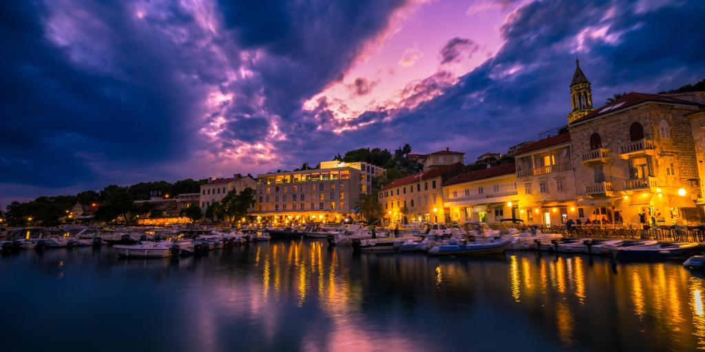 Harbour of Hvar in the evening with boats and lights reflecting on the water