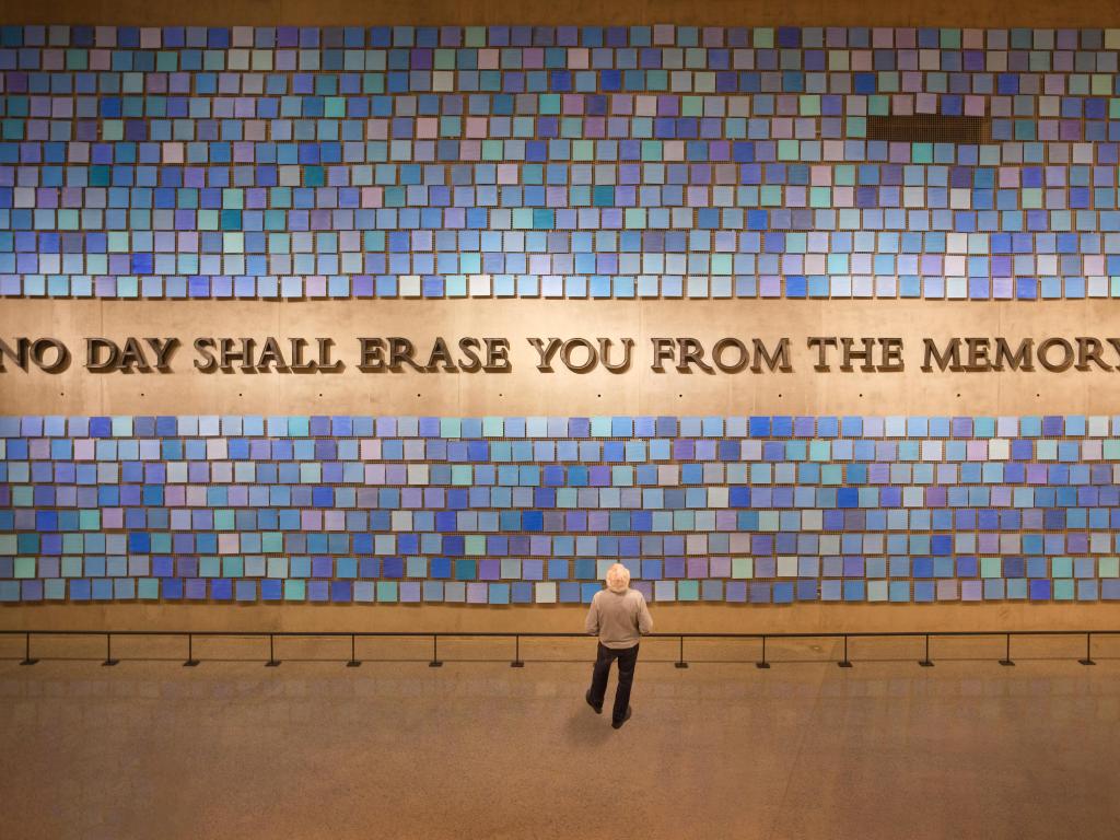 Visitor reading Virgil quote in the Memorial Hall at the 9/11 Memorial and Museum, New York