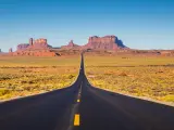 Classic panorama view of historic U.S. Route 163 running through famous Monument Valley