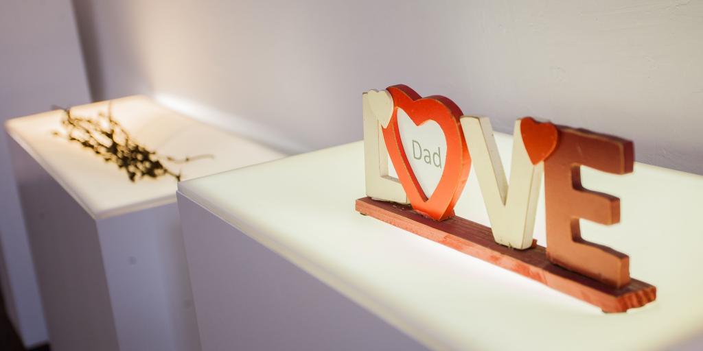 A photo frame spelling out the word LOVE with a piece of paper saying 'dad' inside