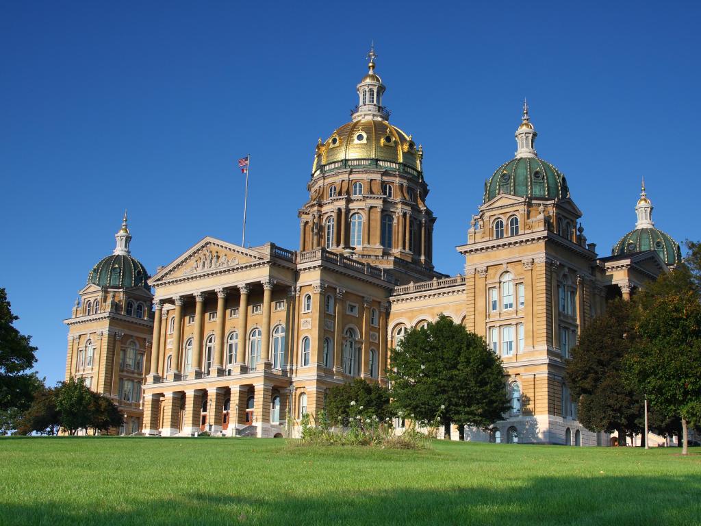 Majestic and expansive capitol building with a golden-colored dome and several smaller domes