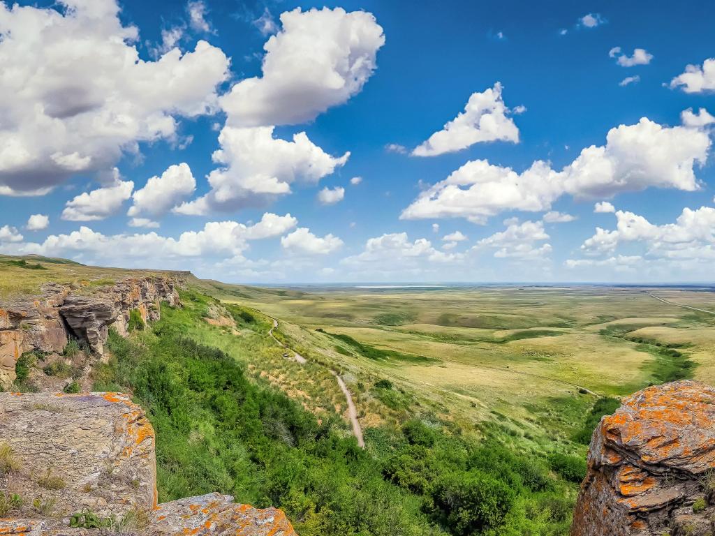 Beautiful aerial view of Canadian Prairie at Head-Smashed-In Buffalo Jump world heritage site in Southern Alberta on a sunny day with blue sky and clouds in summer, Canada