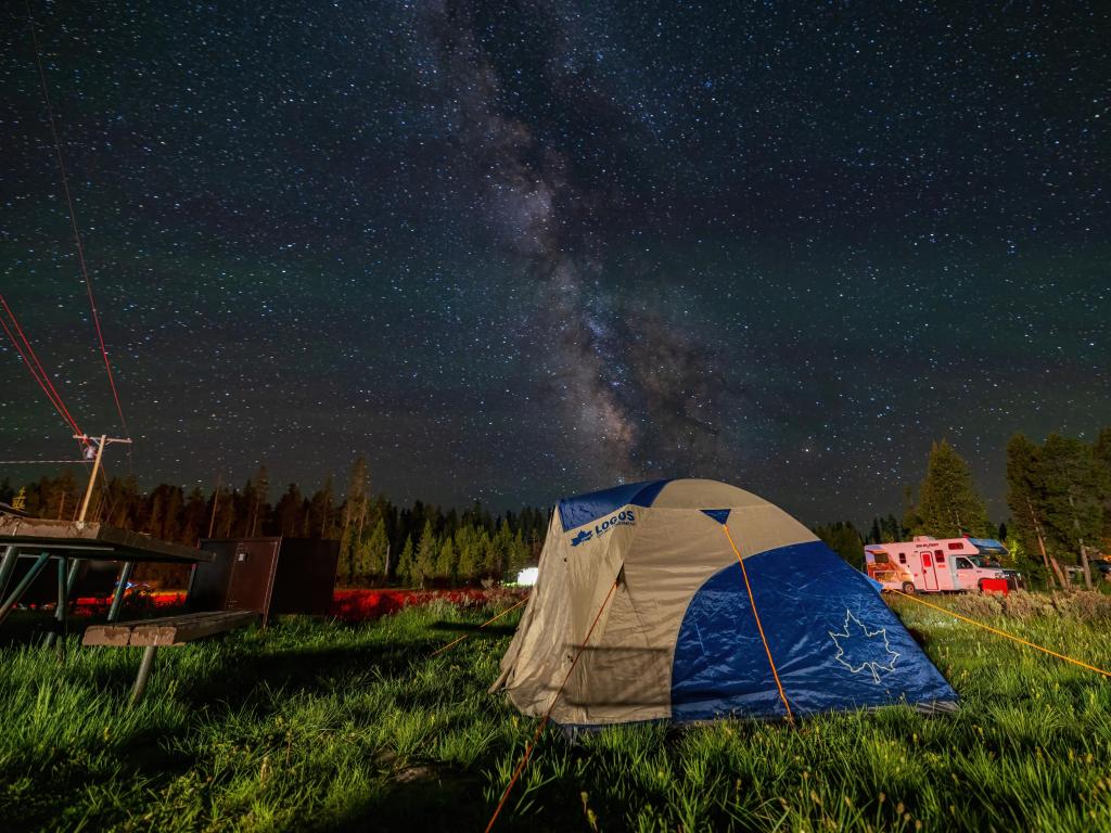 Night milky way and sky over a tent in Bridge Bay Campground