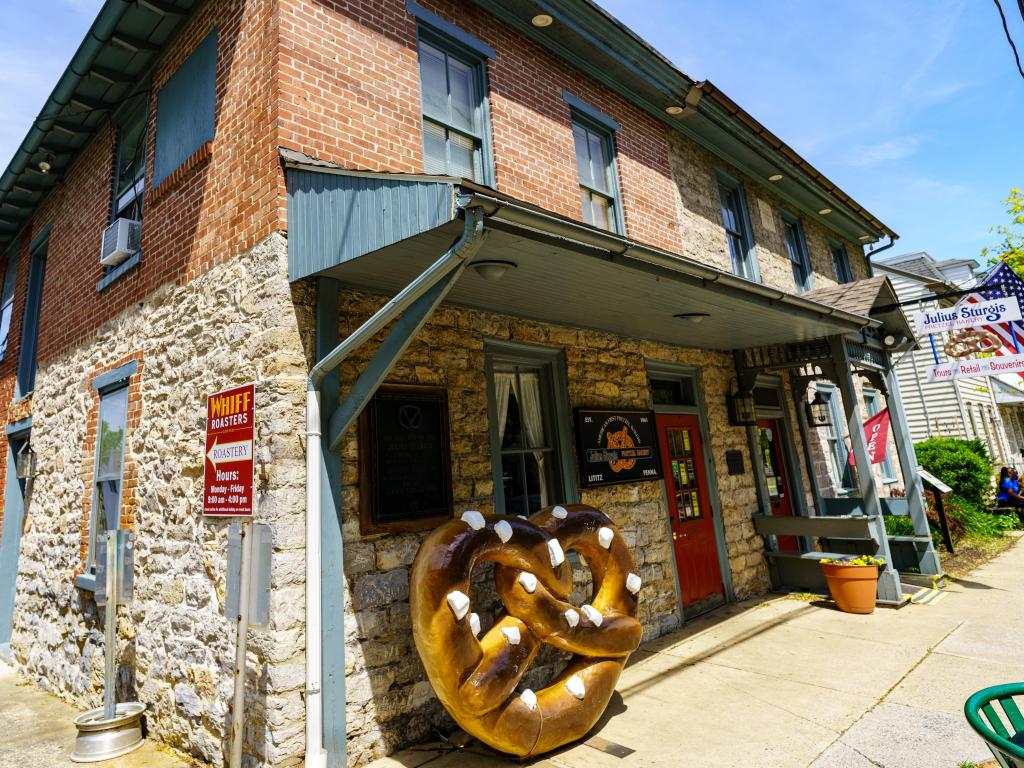 Exterior view of the Julius Sturgis Pretzel Bakery with a distinctive large pretzel sign.
