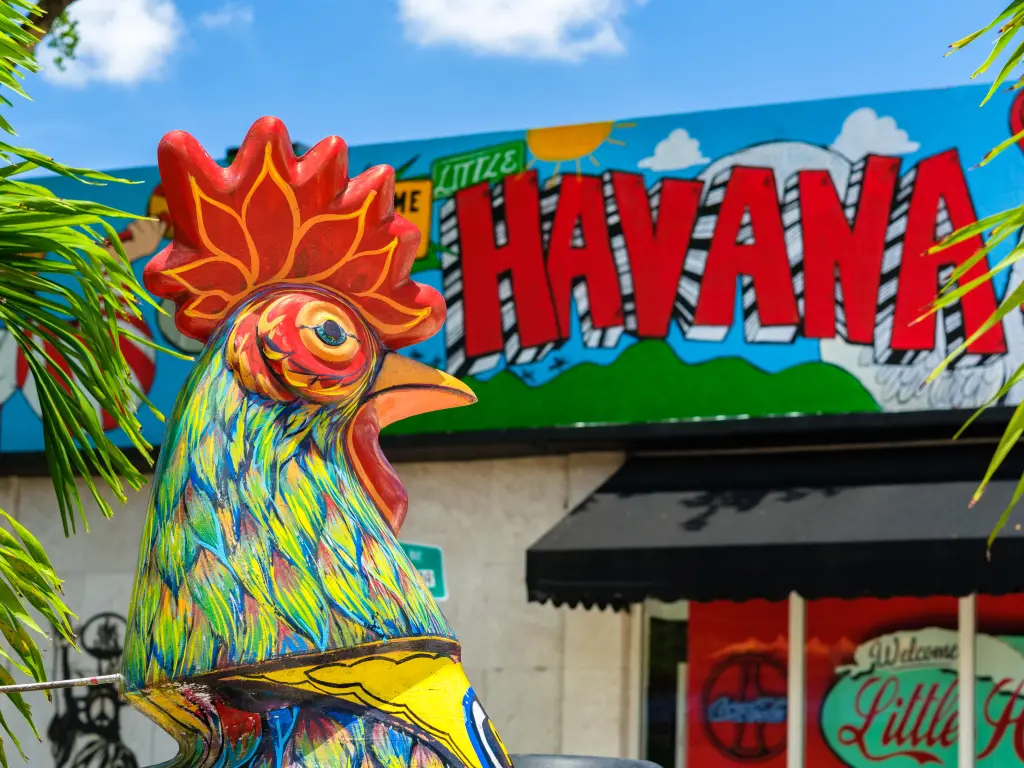 Colorful chicken statue with a sign that reads "Little Havana", on a sunny day in Calle Ocho district