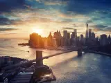 Sun setting over Manhattan Island, Brooklyn Bridge and Hudson River 