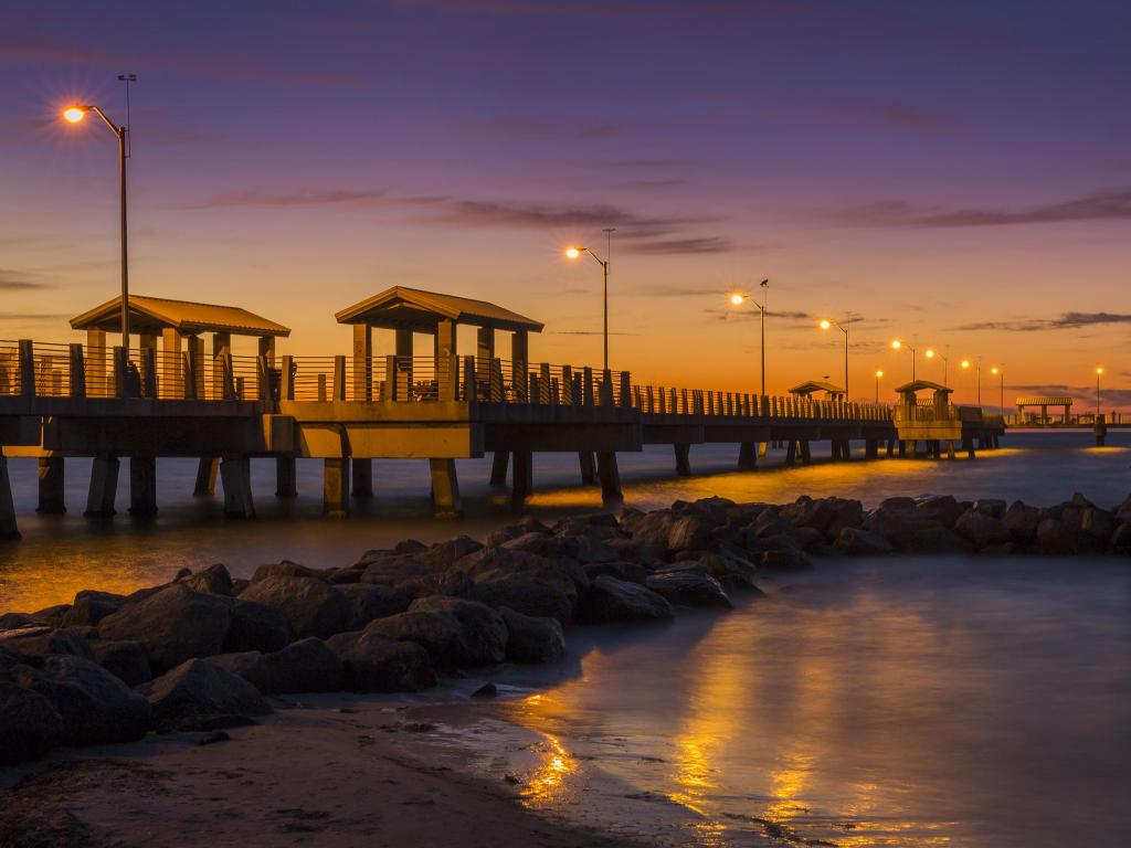 Fisting Pier at sunset in St Petersburg, FL, with calm sea and a purple-hued sky