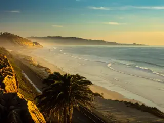 San Diego, California, USA with a sunset and marine layer at the Torry Pine beach, facing La Jolla city.