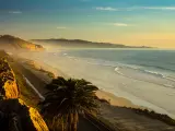 San Diego, California, USA with a sunset and marine layer at the Torry Pine beach, facing La Jolla city.