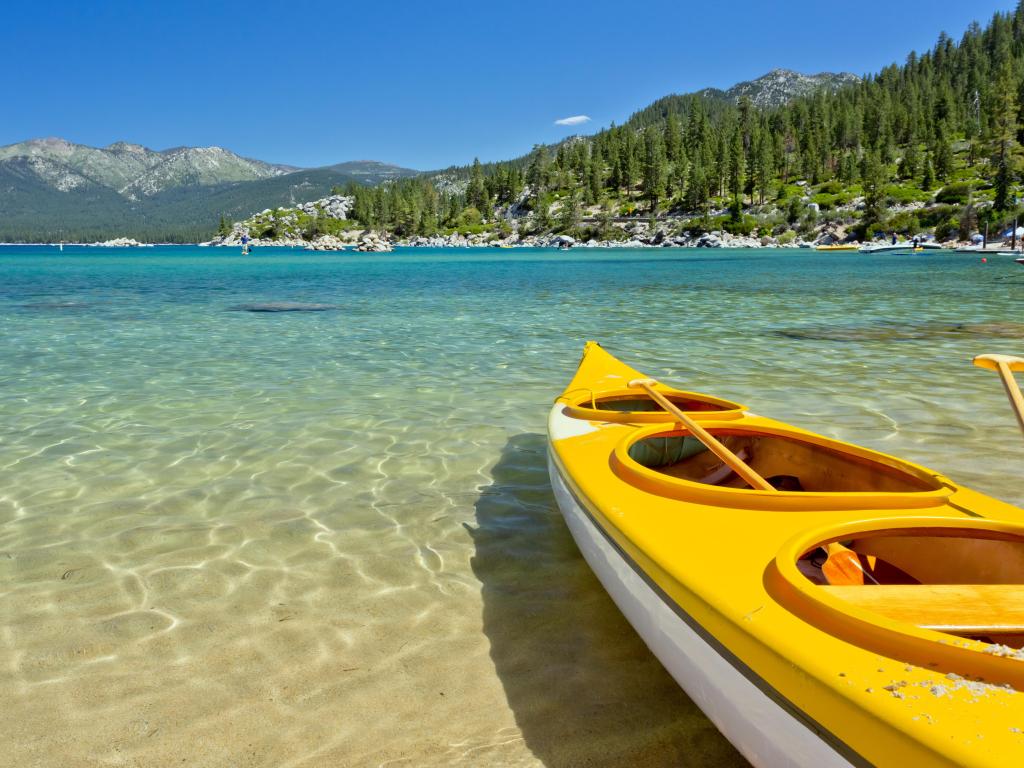 A yellow Kayak on Lake Tahoe on a sunny day with blue skies