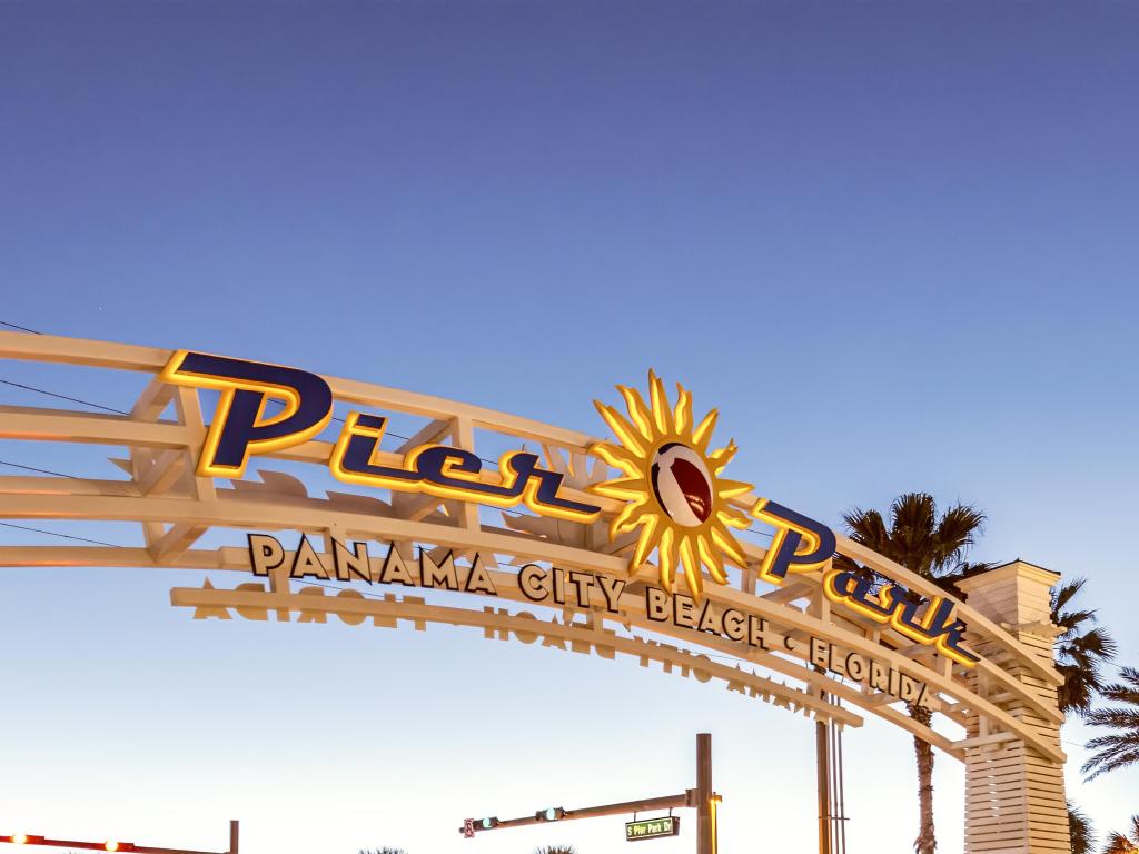 Panama City Beach Pier entrance sign at sunset, Florida.