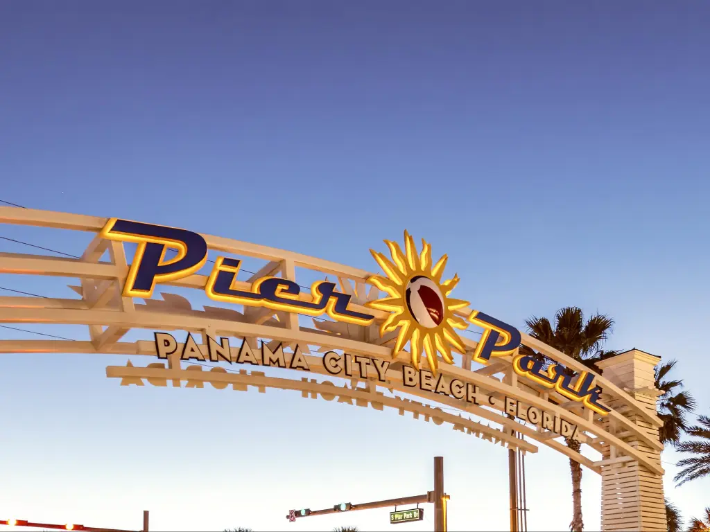 Panama City Beach Pier entrance sign at sunset, Florida.