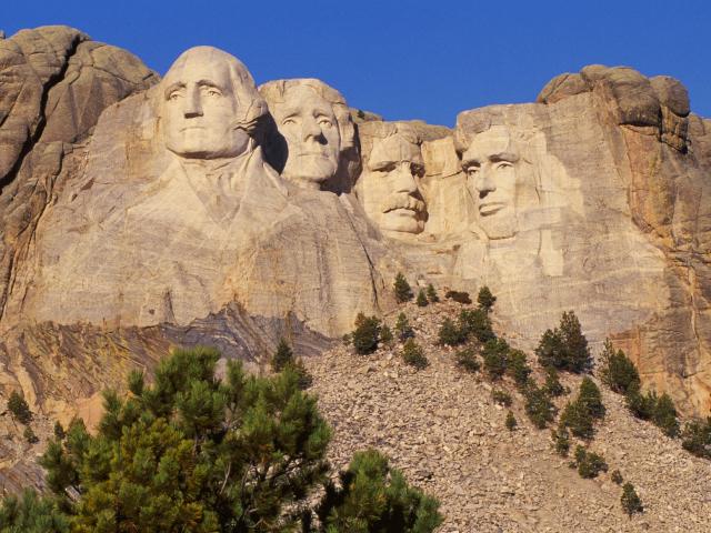 Mount Rushmore mountain with US Presidents carved into the rock.
