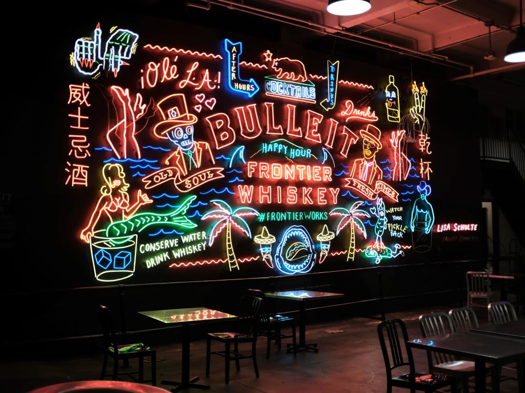 Art installation at Grand Central Market, Los Angeles - bright neon signage with tattoo-style characters and text