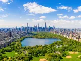 Aerial view of the Central park in New York with golf fields and tall skyscrapers surrounding the park.