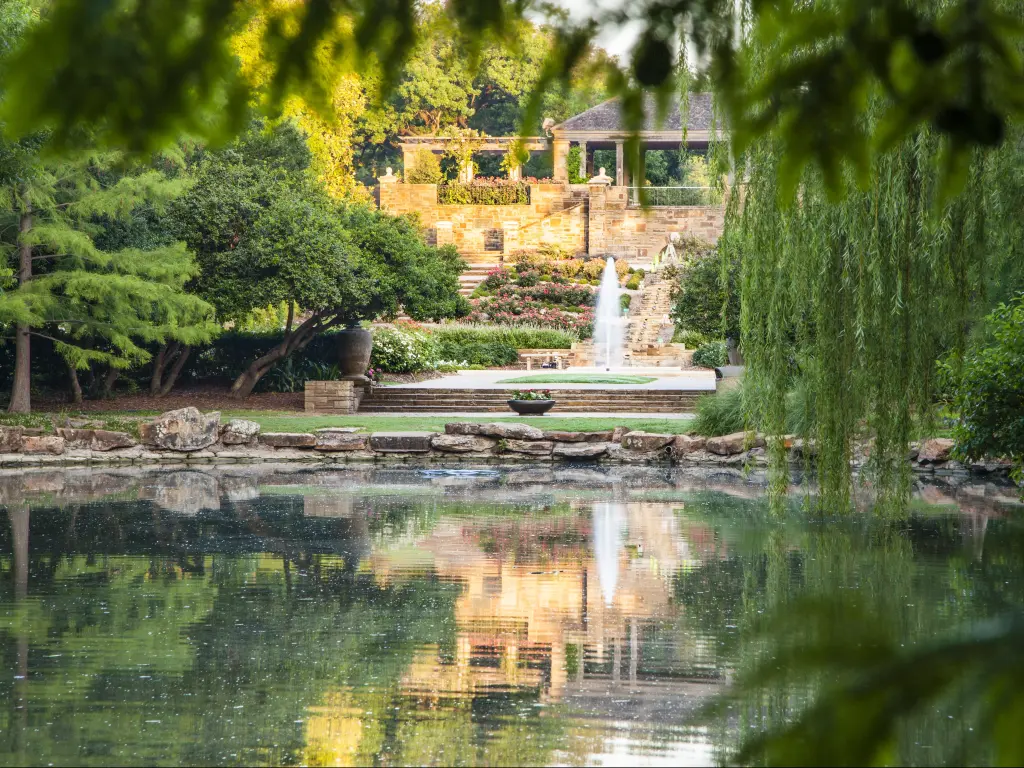 Tranquil pond with reflections at Fort Worth Botanical Garden on a bright day