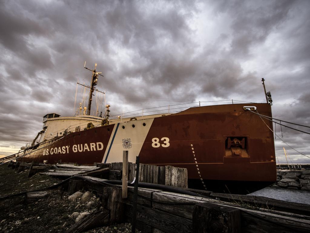 USCGC Mackinaw a retired US Coast Guard icebreaker, A red museum ship at the port in Mackinaw Michigan in a gloomy afternoon