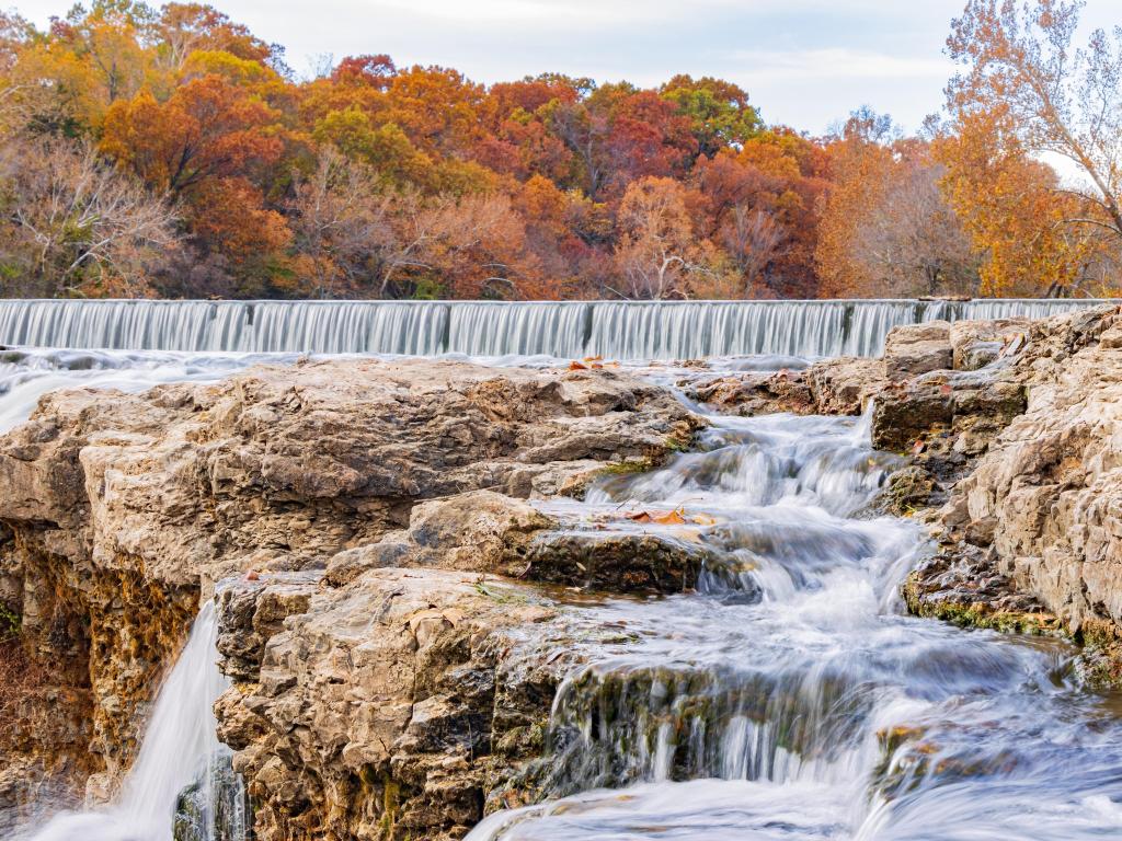 Overcast view of the fall colors of Grand Falls at Joplin, Missouri, USA.