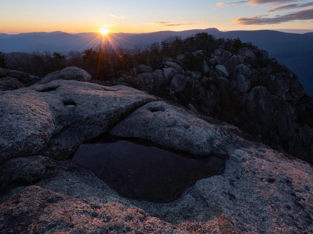 Sunset at Old Rag in Shenandoah National Park, with the last rays of light peeking out from behind the mountain at twilight