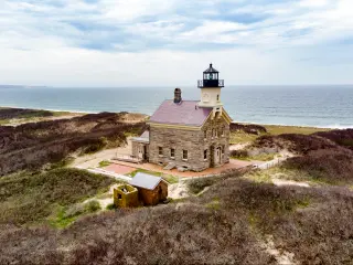 Classic lighthouse building looking out to sea on Block Island, Rhode Island.