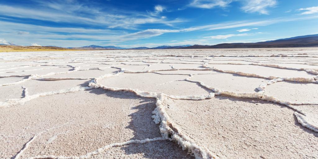 The white salt flats of the Salinas Grandes, Argentina, with a mountain in the distant background