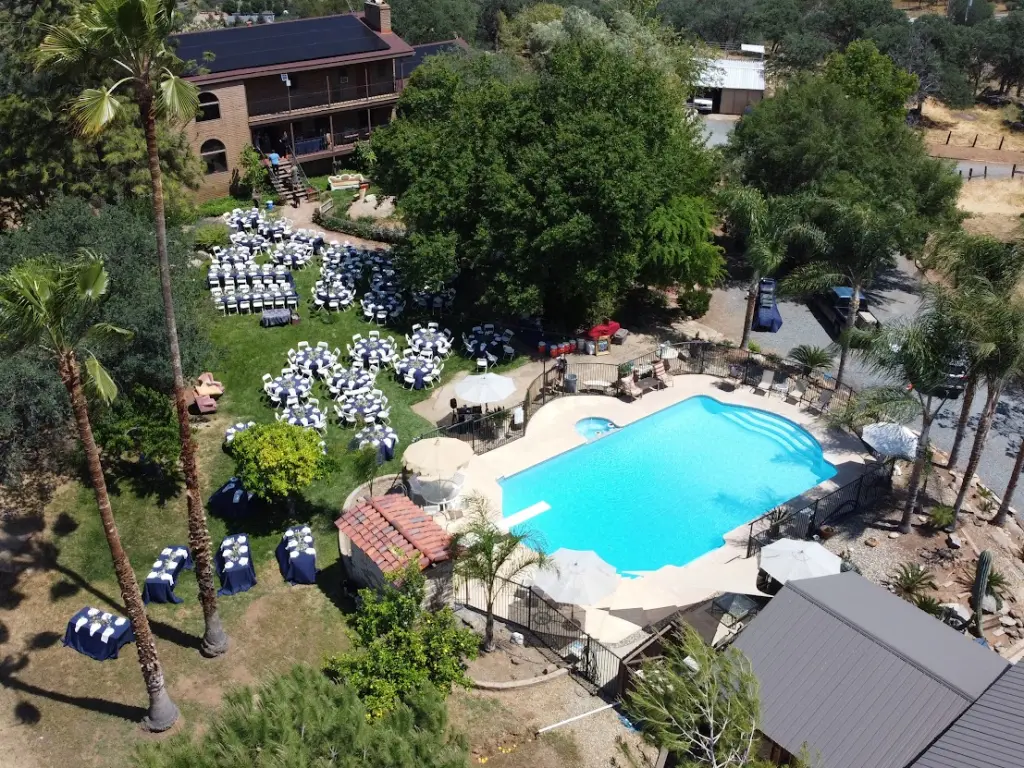 Aerial view of the bed and breakfast with a big pool and outdoor seating area in view