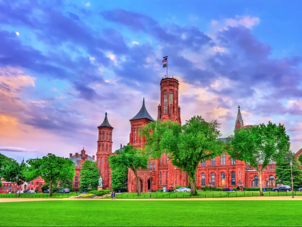 Smithsonian Castle in Washington DC with brighly lit evening sky in the background.