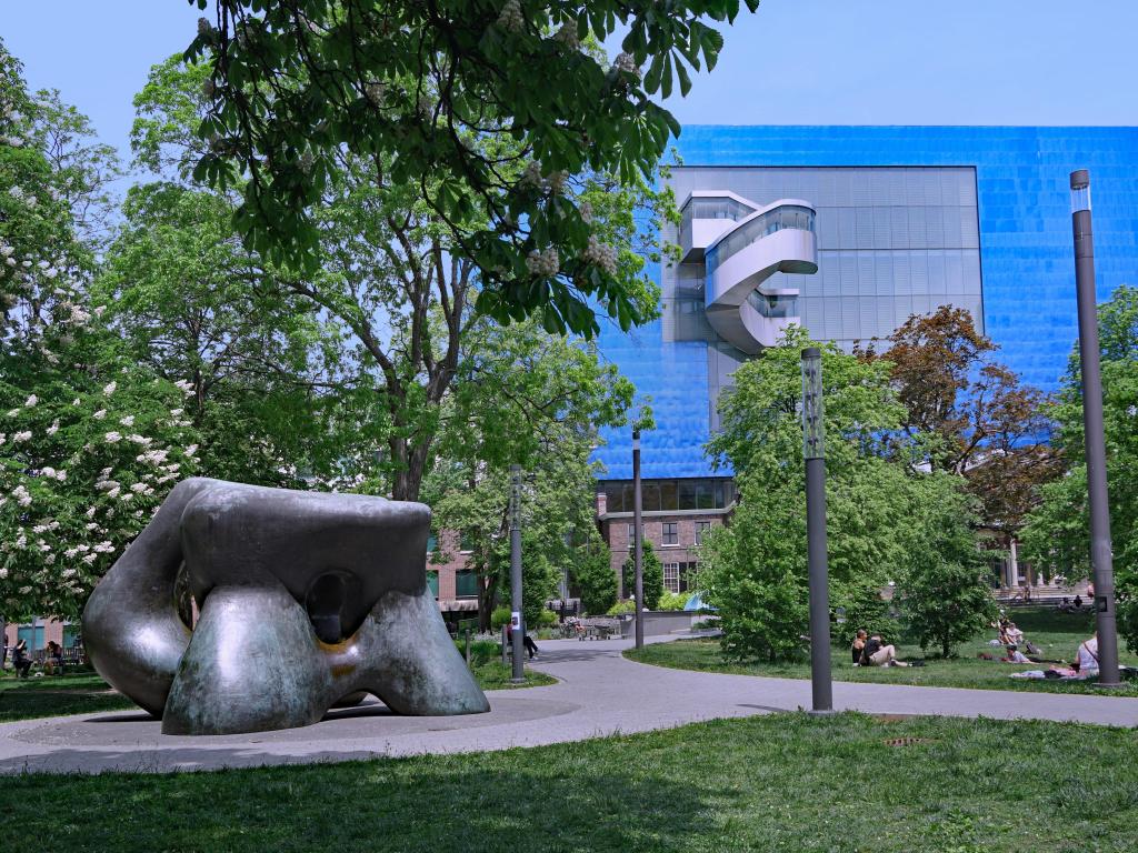 Henry Moore sculpture in the park, with Art Gallery of Ontario designed by Frank Gehry in the background on a sunny day