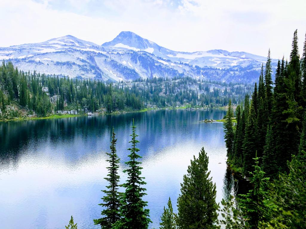 Wallowa Whitman National Forest with view of eagle cap, mountains in the distance and a lake in the foreground.