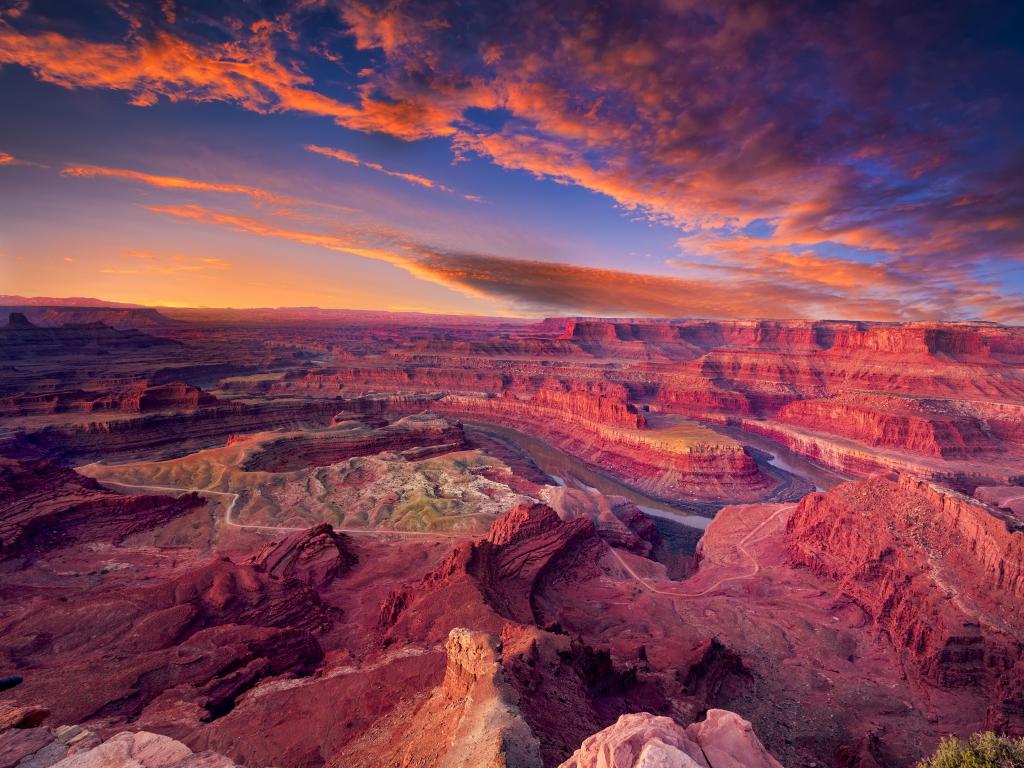 Dead Horse Canyon, Moab, Utah, USA taken just before sunrise with the Colorado River surrounded by the red rocks under a dramatic sky.