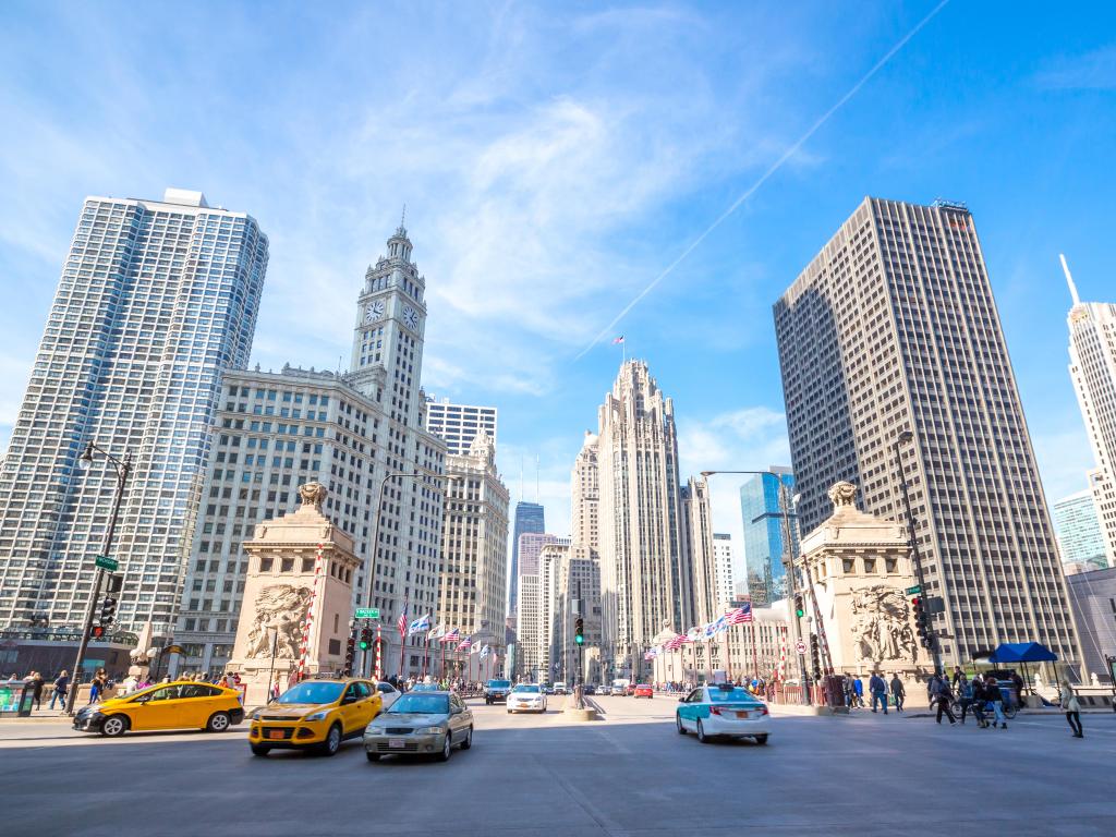 Chicago, USA with the downtown city in the background and cars in the foreground taken against a blue sky.