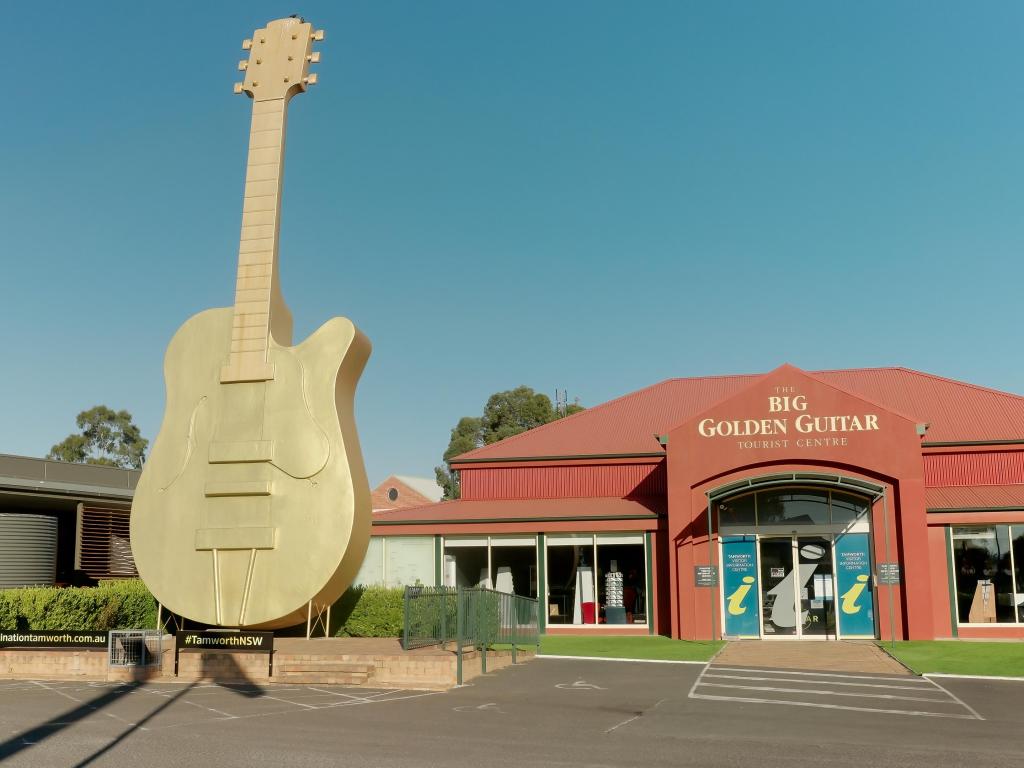 Golden guitar statue outside an information center in Australia on a sunny day