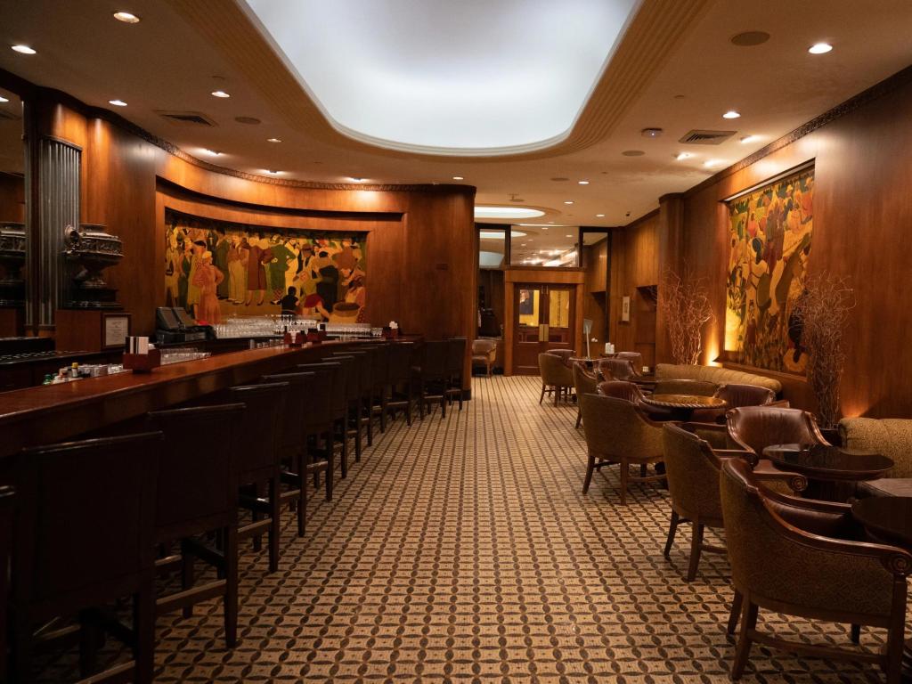 Traditional and elegant wooden panelled cocktail bar and lounge at The Roosevelt Hotel New Orleans