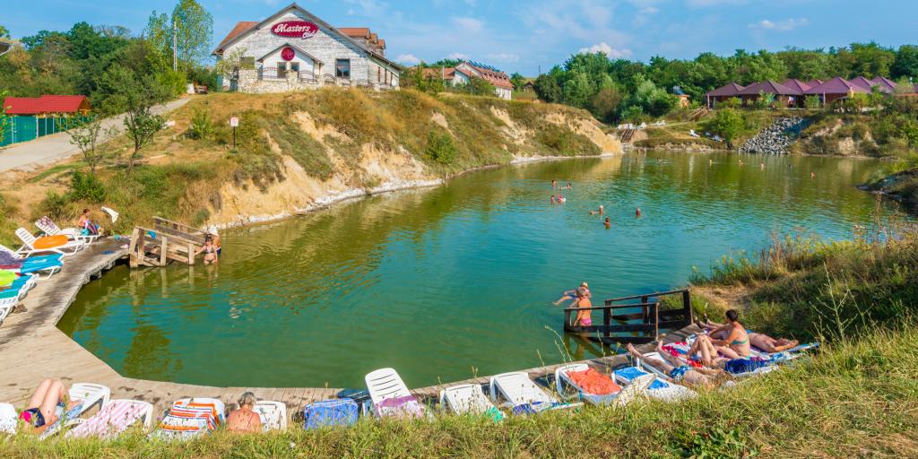 People swimming and sunbathing at Ocna Sibiului thermal salt lake, Romania