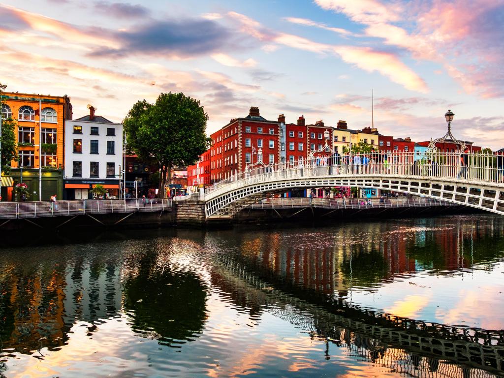 Dublin, Ireland. Night view of famous illuminated Ha Penny Bridge in Dublin, Ireland at sunset