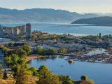 Kelowna, British Columbia, Canada with a high resolution panorama of the city skyline and Okanagan Lake with the R W Bennett Bridge in the background, from Knox Mountain at sunset.