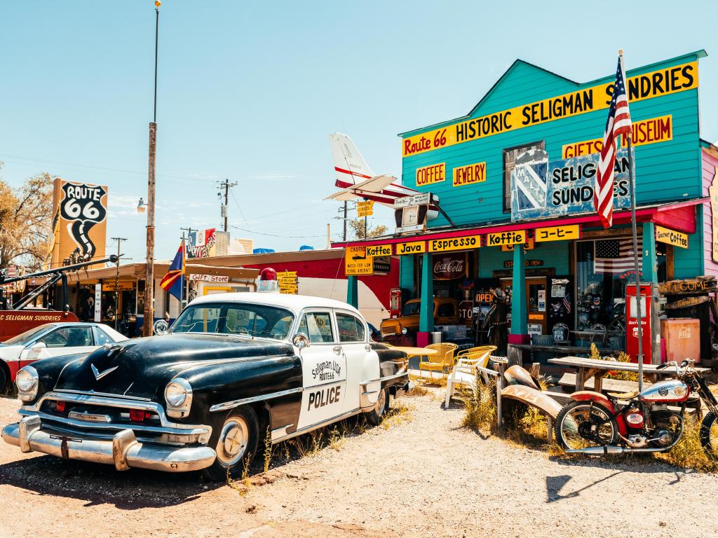 Colorful historic Route 66 Store in Seligman, Arizona, on a sunny day with a vintage police car parked outside