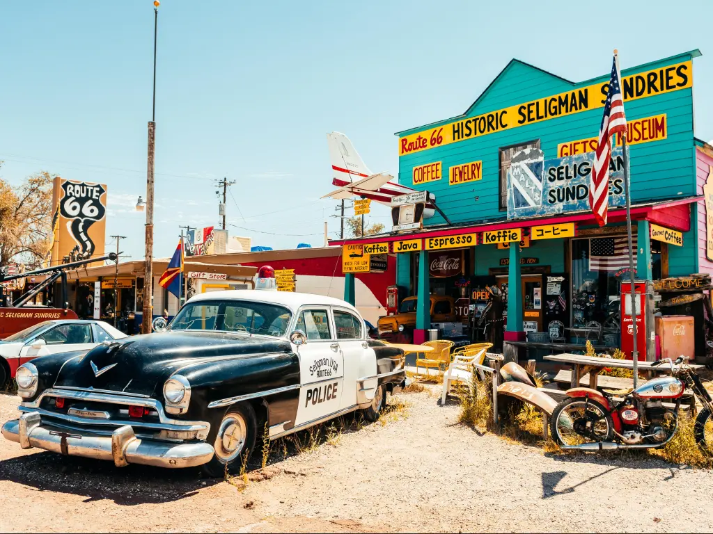 Colorful historic Route 66 Store in Seligman, Arizona, on a sunny day with a vintage police car parked outside