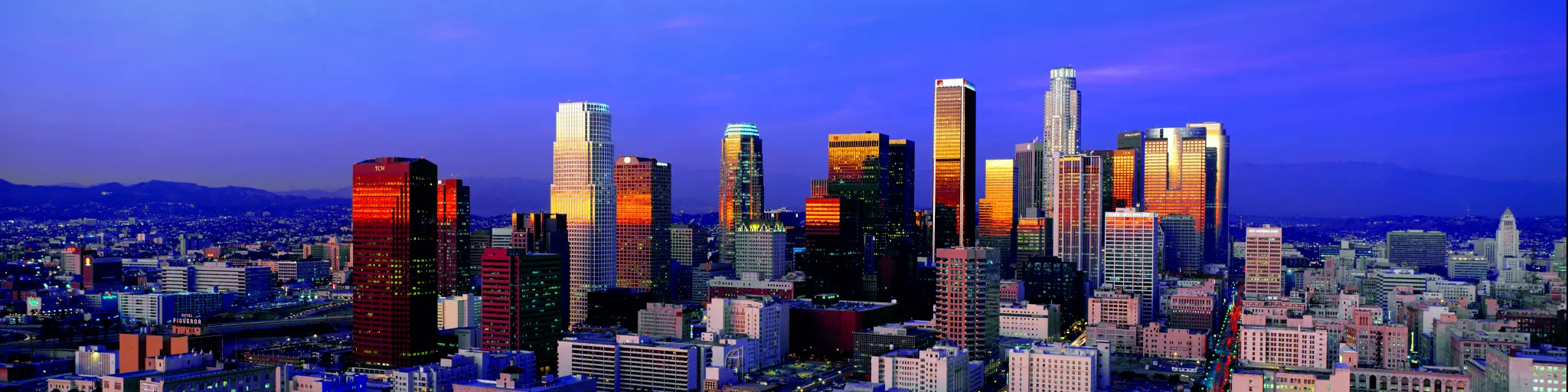 A beautiful view of the skyline with the light from the sunrise reflecting the buildings of Los Angeles