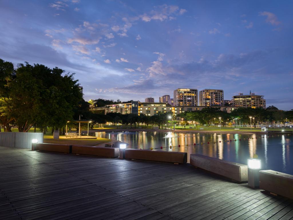 Darwin, Australia waterfront precinct taken at night with the skyline in the distance and the water in the foreground.