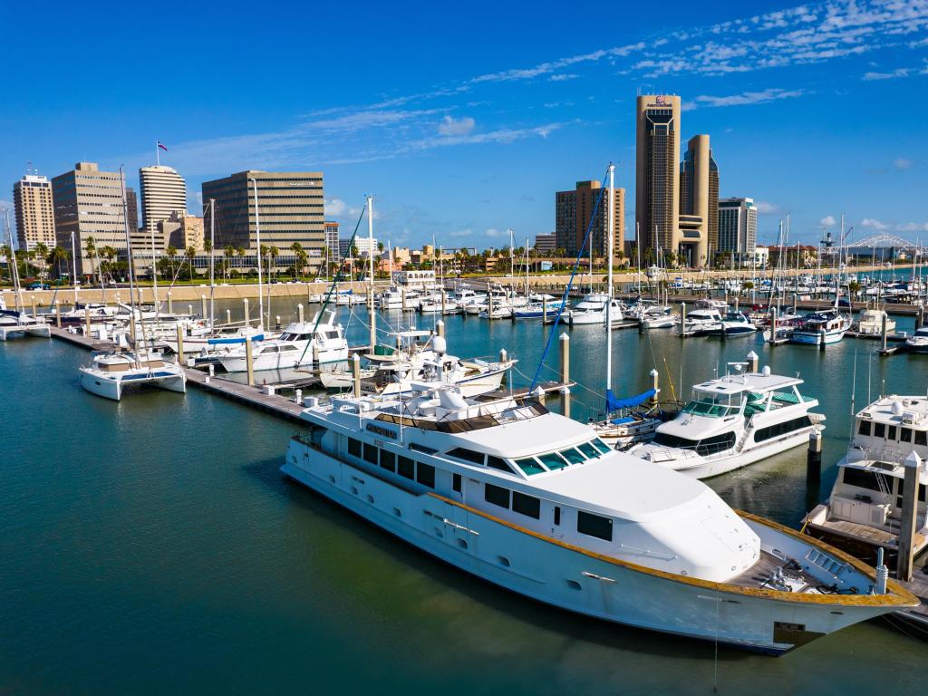 Boats and yachts docked in the Corpus Christi Bay Marina with City skyline in the background