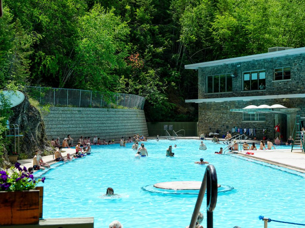 Hot springs pool, people sitting around and soaking in it