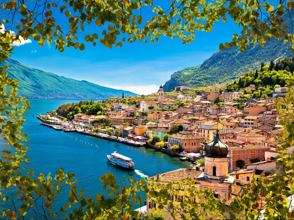 Limone sul Garda waterfront view through green leaves frame, Lombardy region of Italy