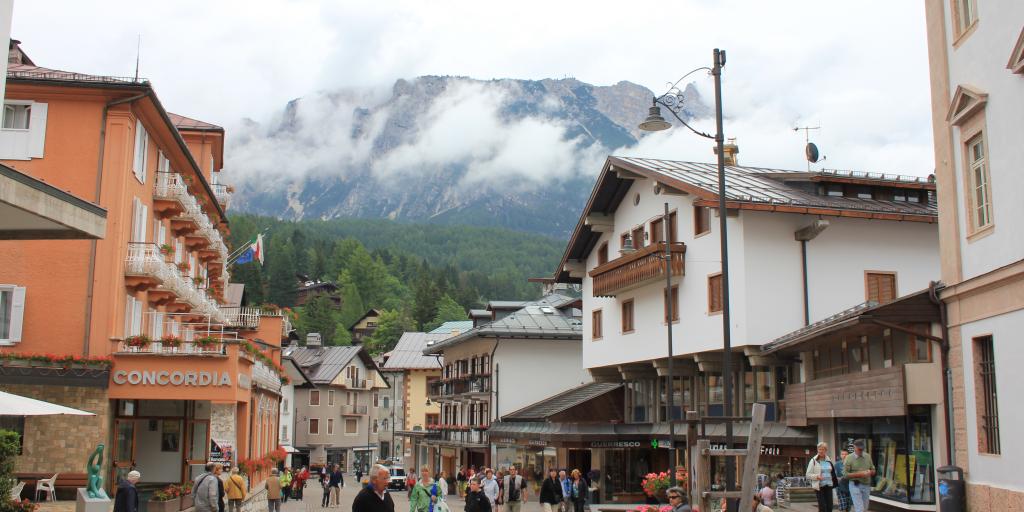 Shoppers and visitors walk through the pedestrian ski town centre of Cortina d'Ampezzo, Italy