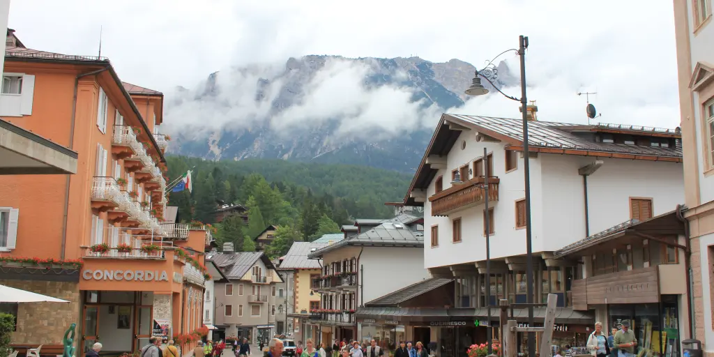 Shoppers and visitors walk through the pedestrian ski town centre of Cortina d'Ampezzo, Italy