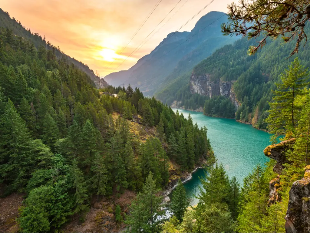Diablo Lake in North Cascades National Park at sunrise surrounded by mountains and forest.