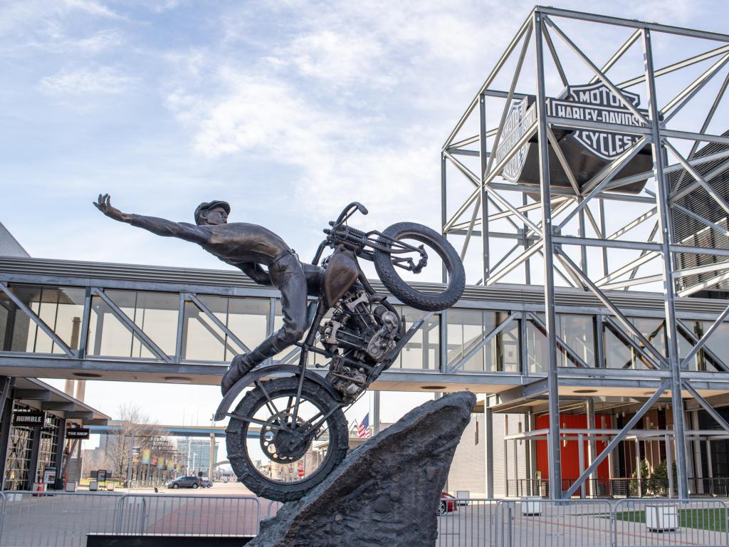 Exterior of the Harley-Davidson Museum in Milwaukee with a bronze statue of a motorcycle rider in focus