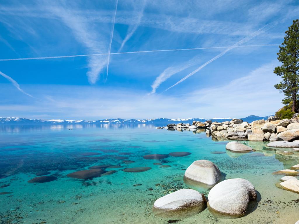 Lake Tahoe, California, USA with a blue sky and mountains in the distance.