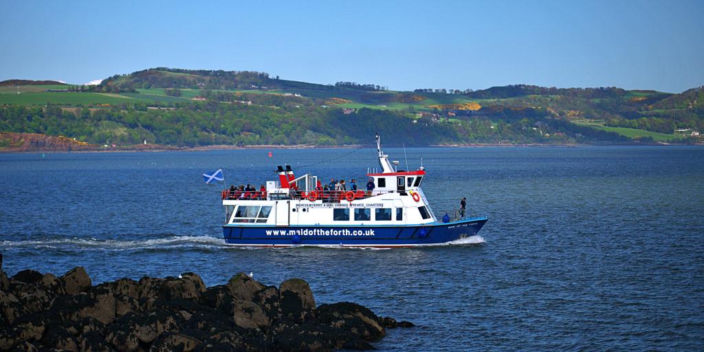 A ferry boat carries passengers through the Firth of Forth to Inchcolm Island near Edinburgh in Scotland